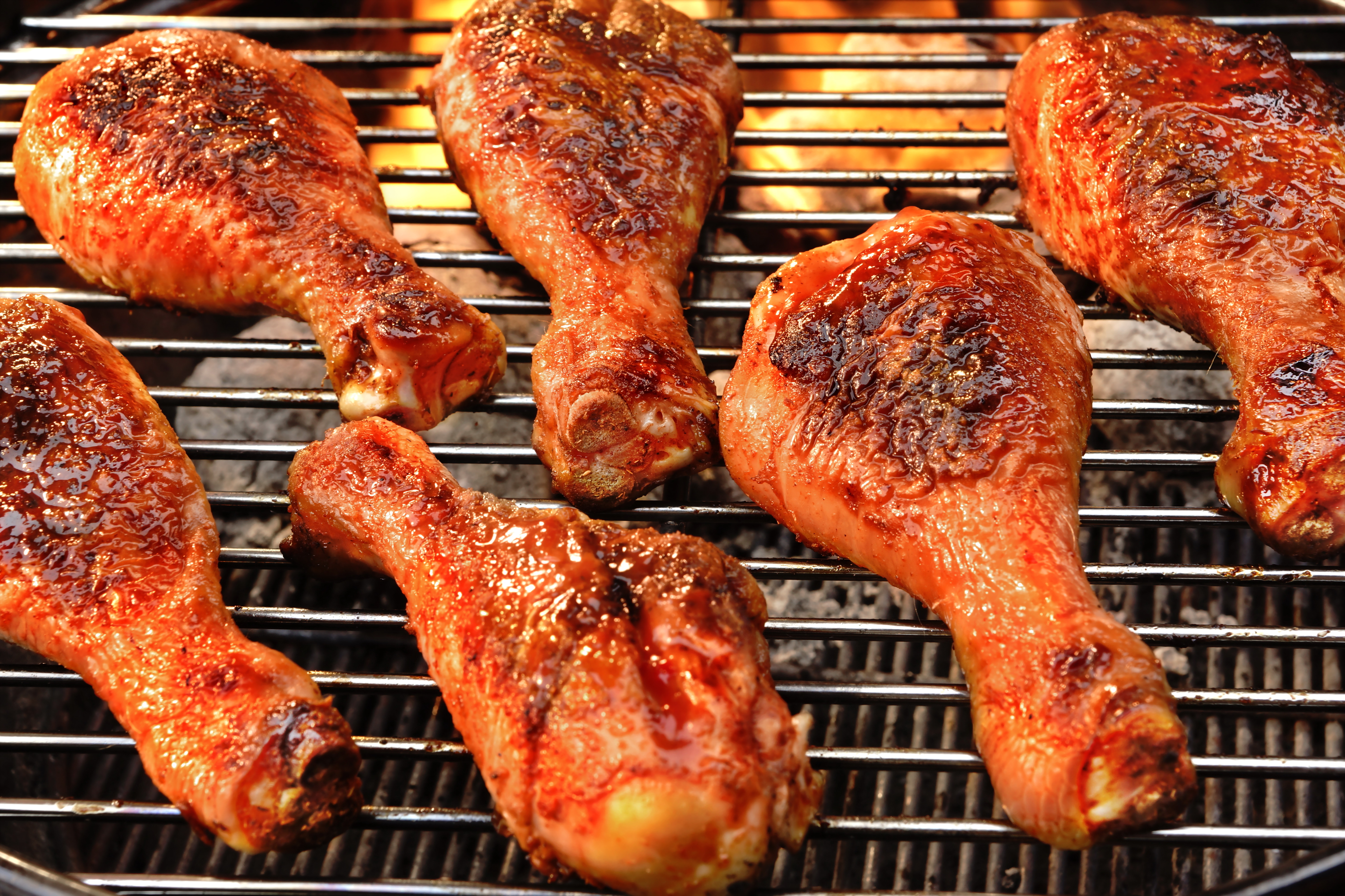 BBQ Chicken Legs Roasted On The Hot Flaming Charcoal Grill, 